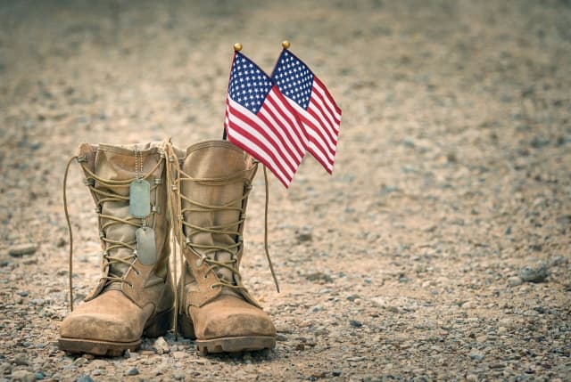 Military boots with American flag waving